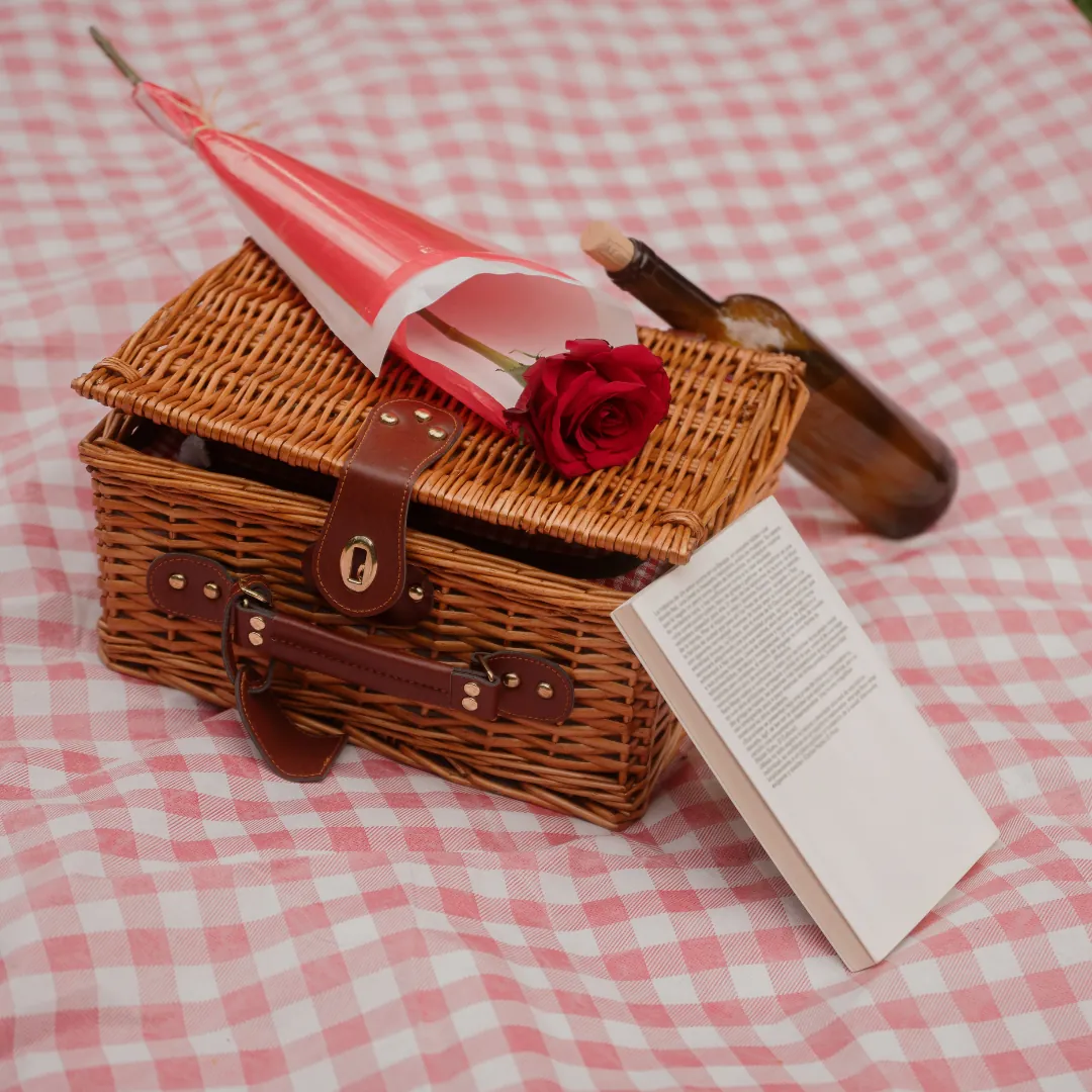 A wicker picnic hamper on a gingham cloth